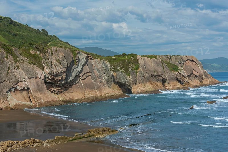Distinctive rock cliffs as a geological formation of rock layers, Flysch on Itzurun Beach in Zumaia, Spain