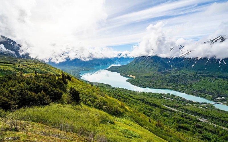 View of snowy mountains in spring and turquoise blue Kenai Lake, Slaughter Ridge Trail, Cooper Landing, Kenai Peninsula, Alaska, USA
