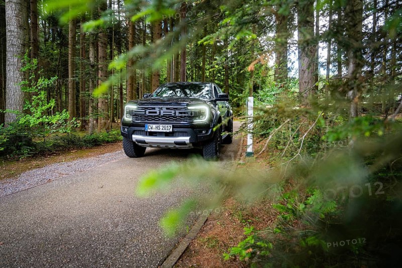 Car driving on a summer forest road surrounded by green vegetation, district service with Björn Hartmann Sicherheit, Oberreichenbach, Calw district, Germany