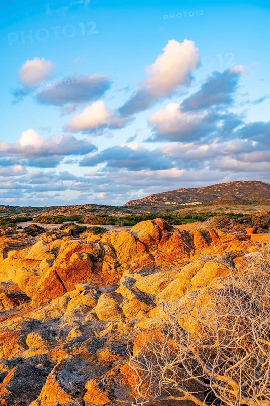 Evening atmosphere with clouds over the landscape at Marinedda Coast on a sunny day, Sardinia, Italy
