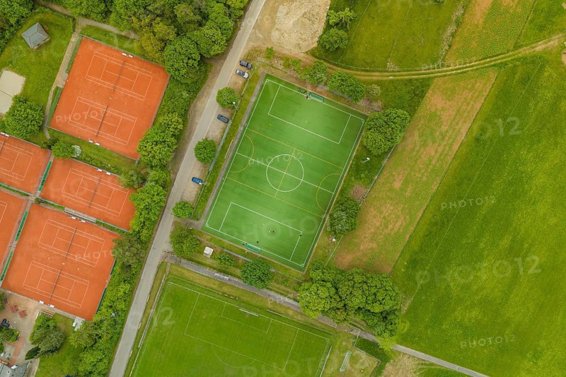 Aerial view showing soccer field and several tennis courts surrounded by nature, Aidlingen sports field, Böblingen district, Germany