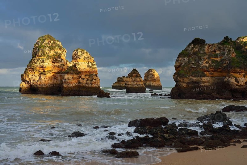 Rock formations on the coast in the evening light, Praia do Camilo, Lagos, Algarve, Portugal