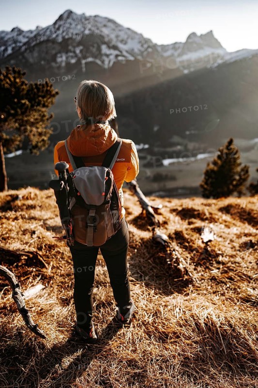 Hiker in the Allgäu at sunset in spring on the Zirmgrat near Pronten in the Allgäu