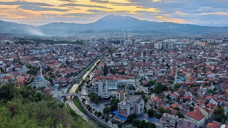 City view at sunset with mountains in the background and a river, Bistrica flowing through the city, Prizren, Kosovo