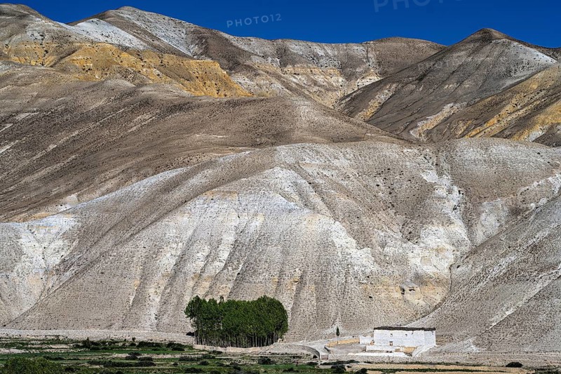 Traditional house in front of mountain landscape, erosion landscape near Lo Manthang, Mustang, Upper Mustang, former kingdom, Himalayas, Nepal