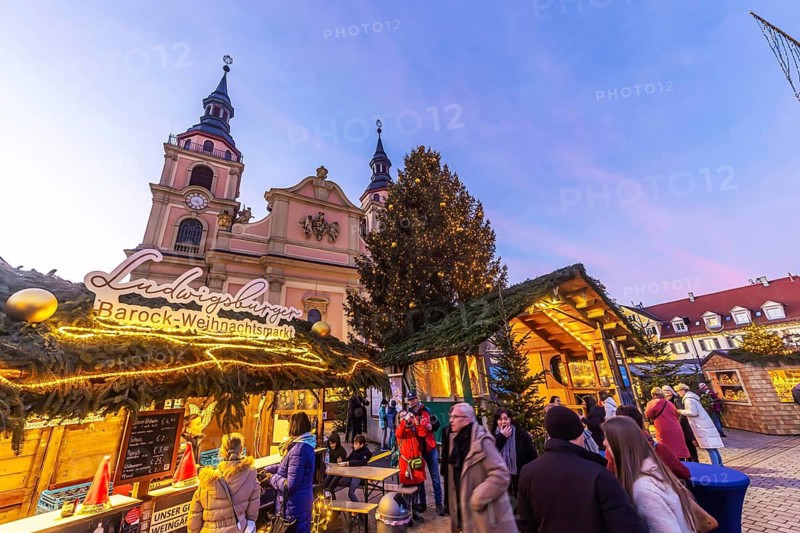 Baroque Christmas market with illuminated angels between the Protestant City Church and the Catholic Church of the Most Holy Trinity. Sights on the market square in the evening. Ludwigsburg, Baden-Württemberg, Germany