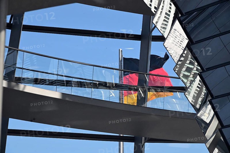 German flag behind glass Reichstag dome