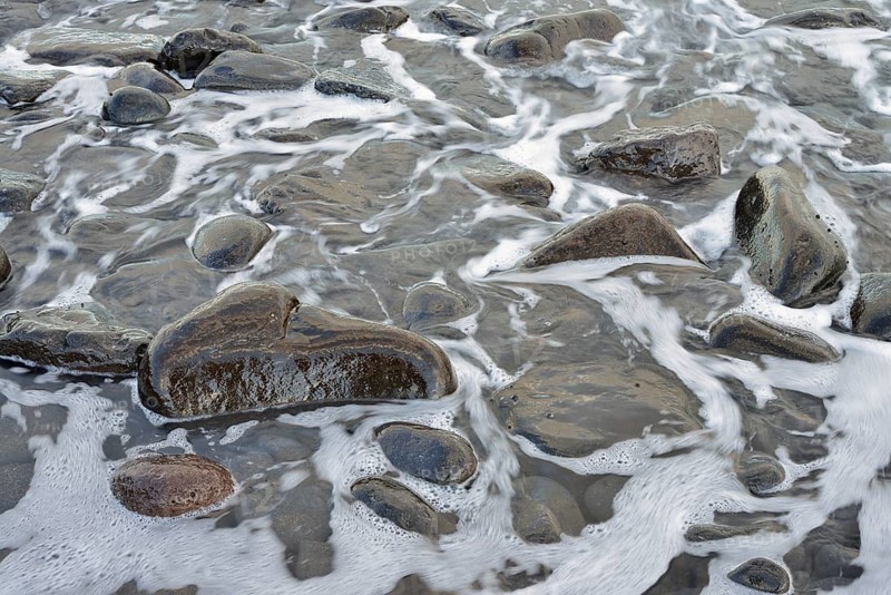 Waves wash stones on the beach, Fuerteventura, Canary Islands, Spain