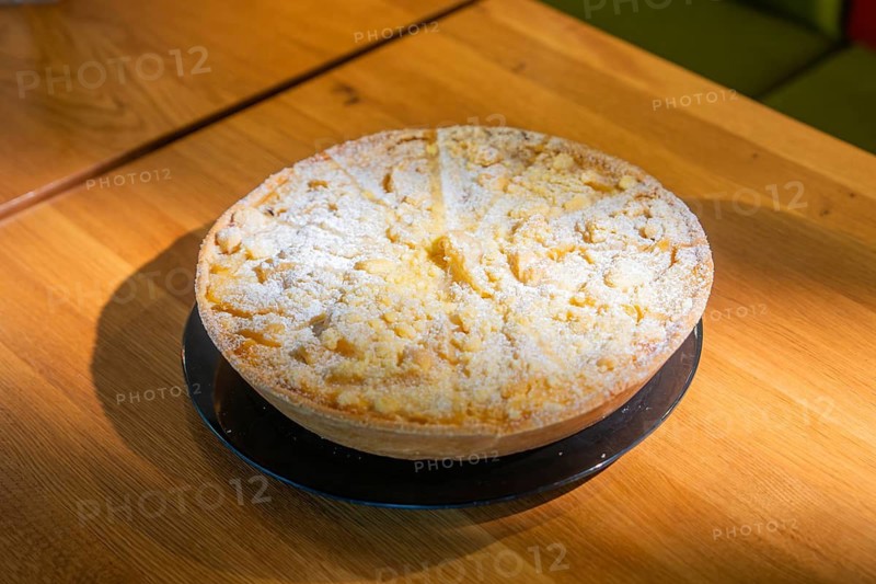 Cake with powdered sugar on a wooden table, ready to serve, Café Kuh, Deckenpfronn, Germany