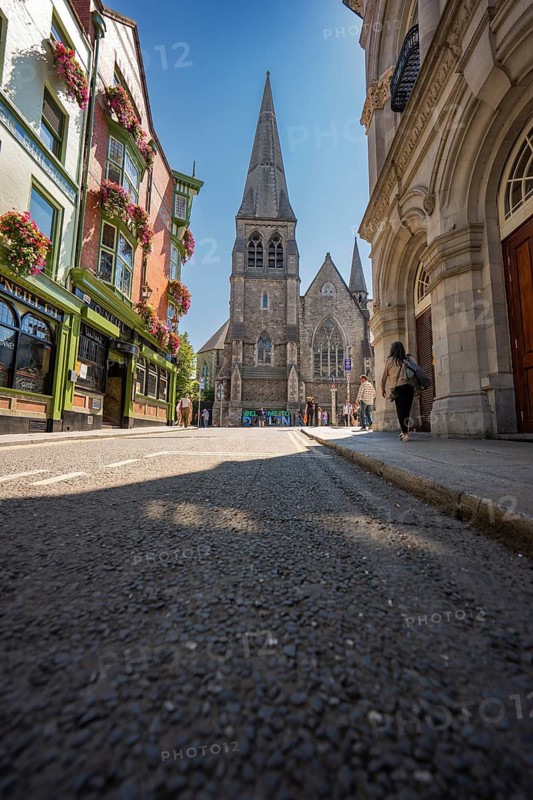 View of a gothic church in the city with colorful flowers and blue sky, Dublin, Ireland