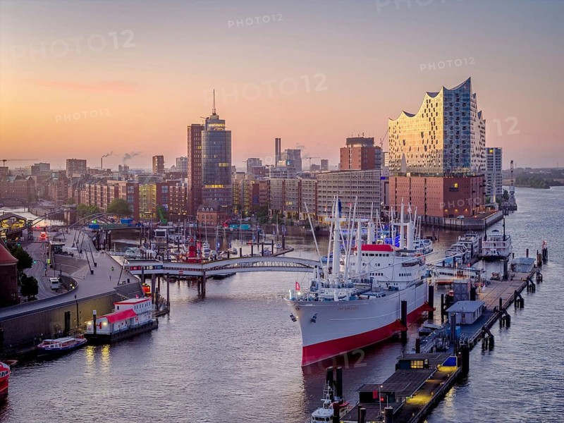 Aerial view of Landungsbrücken (Jan Fedder Promenade) at sunrise on the Elbe with Elbe Philharmonic Hall and Cap San Diego, Hamburg, Germany