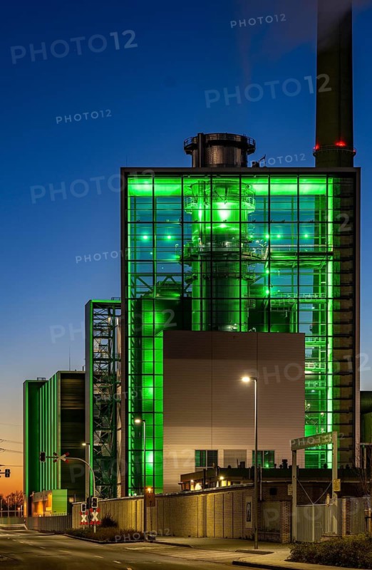 The Lausward combined heat and power plant in Düsseldorf, gas and steam turbine power plant, operated by Stadtwerke Düsseldorf and EnBW, in the harbour of Düsseldorf on the Rhine, green illuminated city window, the chimney of the Fortuna power plant unit, the power plant generates electricity, also traction current and district heating, North Rhine-Westphalia, Germany