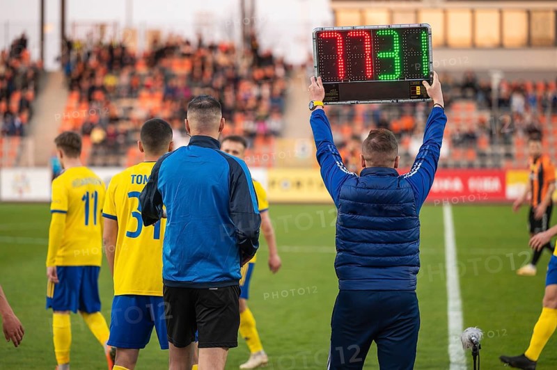 Man shows players substitution during football match in Lubin, Poland