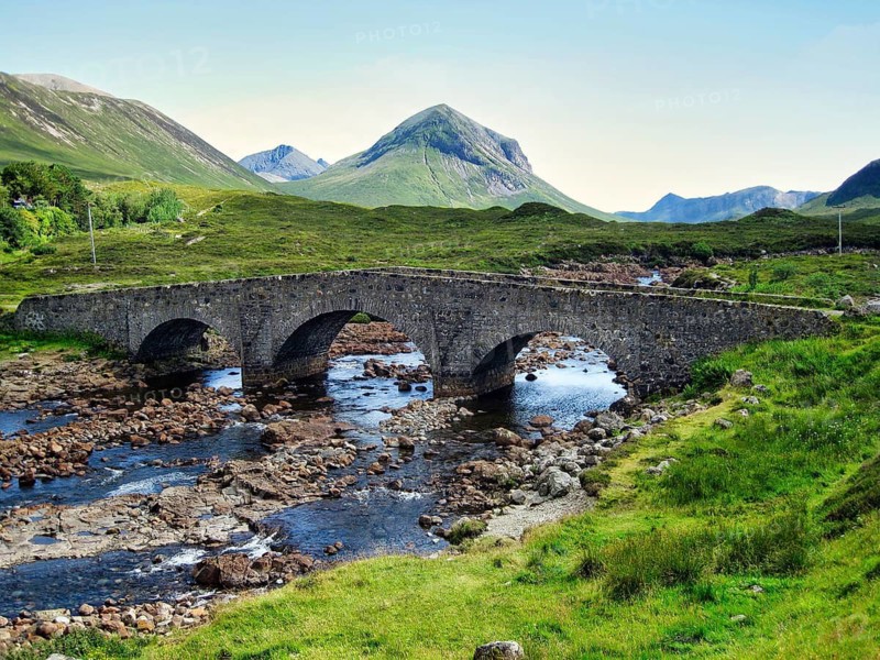 Historic stone bridge, Sligachan Old Bridge, civil engineer Thomas Telford, river landscape, cone-shaped mountain Marsco, Red Cuillin, blue sky, hiking, film set, Scottish island, Isle of Skye, Inner Hebrides, Scotland, United Kingdom