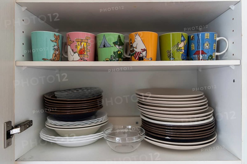 Plates and Moomin cups based on motifs by Tove Jansson, writer, cartoonist, cartoonist, illustrator and paintress, in a cupboard, Finland