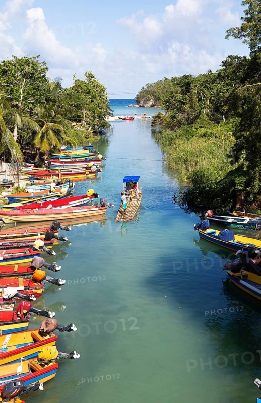 Bamboo raft on the White River or river at Ochos Rios and colorful fishing boats on the shore, Saint Ann Parish and Saint May Parish, West Indies, Caribbean, Central America