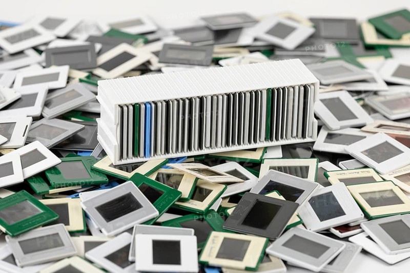 A colorful pile of slides surrounds a filled white slide holder