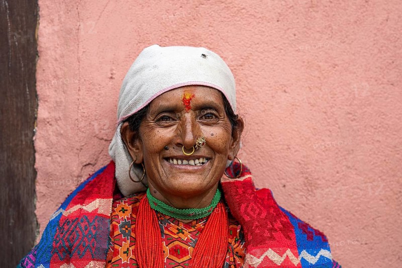 Portrait, friendly smiling elderly woman with traditional jewelry, Hindu ethnic group, Himalayas, Simikot, Humla region, western Nepal, Nepal