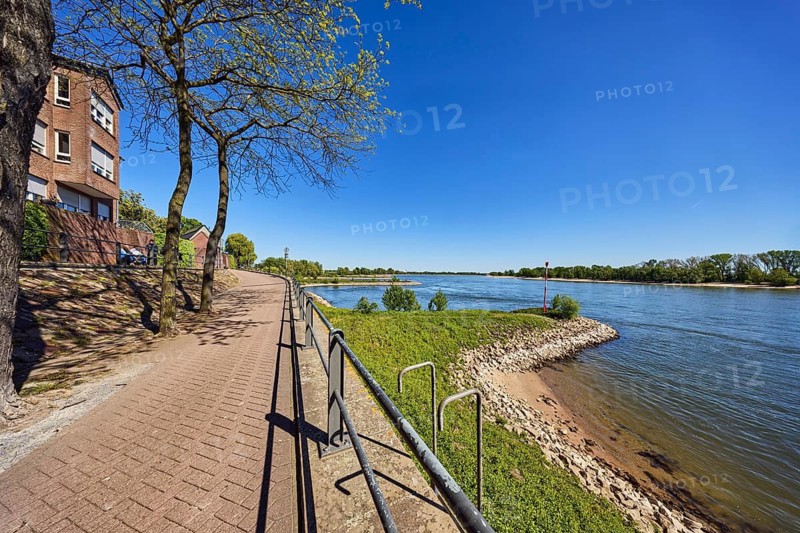 Rhine river, brick building, waterfront, metal railings, riverbank, groves, trees, blue sky, cloudless, Rhine promenade, Rees, Kleve district, North Rhine-Westphalia, Germany