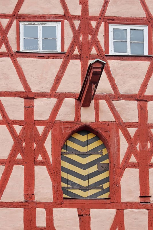Red half-timbered house with beams and pulley as crane and elevator, window, gate, Herrngasse, Coburg, Upper Franconia, Bavaria, Germany