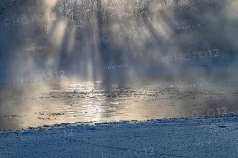 Fog and sunbeams over the freezing river Glomma (Glåma), Alvdal, Hedmark, Innlandet, Norway, February 2026