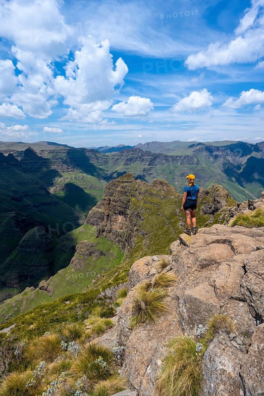 Female mountaineer at the summit of Cathedral Peak or Cathedralpiek or Mponjwana, Drakensberg, KwaZulu-Natal, South Africa