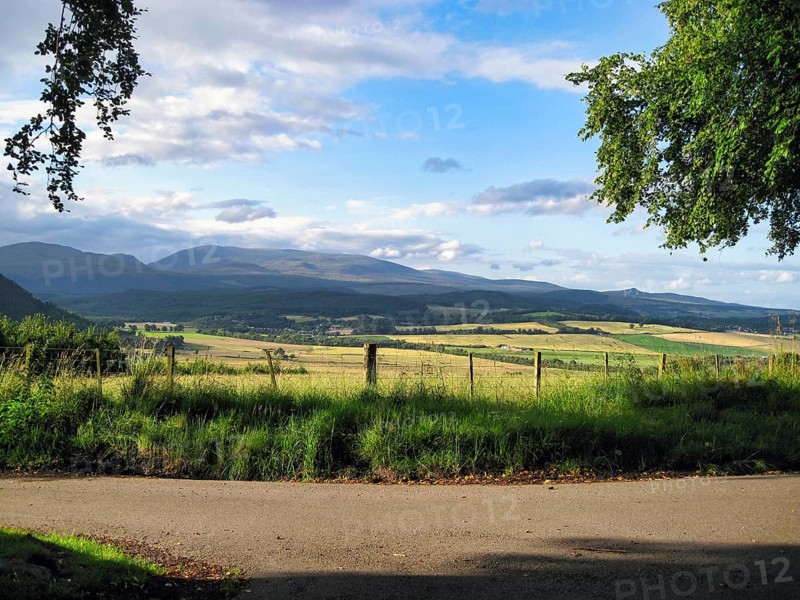View over fields on mountain range, Cumulus, Marybank, Muir of Ord, Strathconon Glen, Scottish Highlands, Scotland, Great Britain