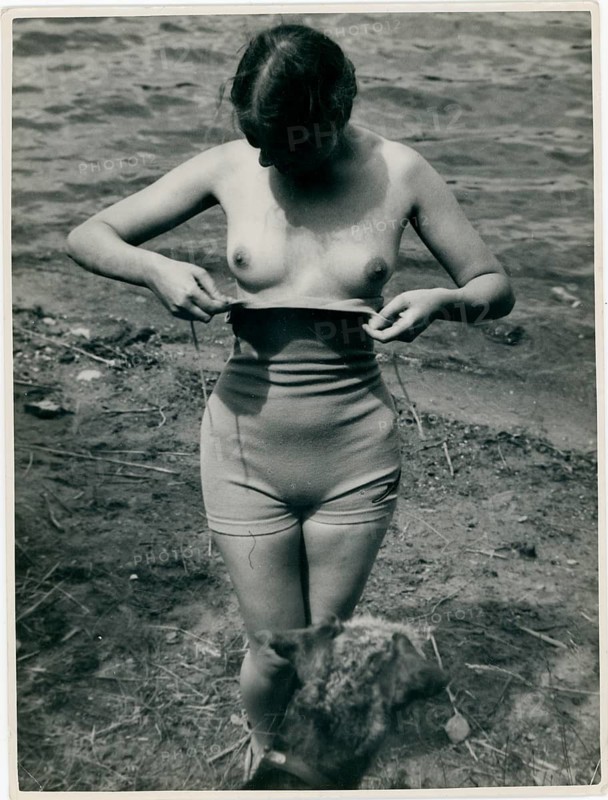 Bathing, swimsuit, undressing, nude, woman at the lake in natural surroundings, the sun shining brightly on the water, around 1935