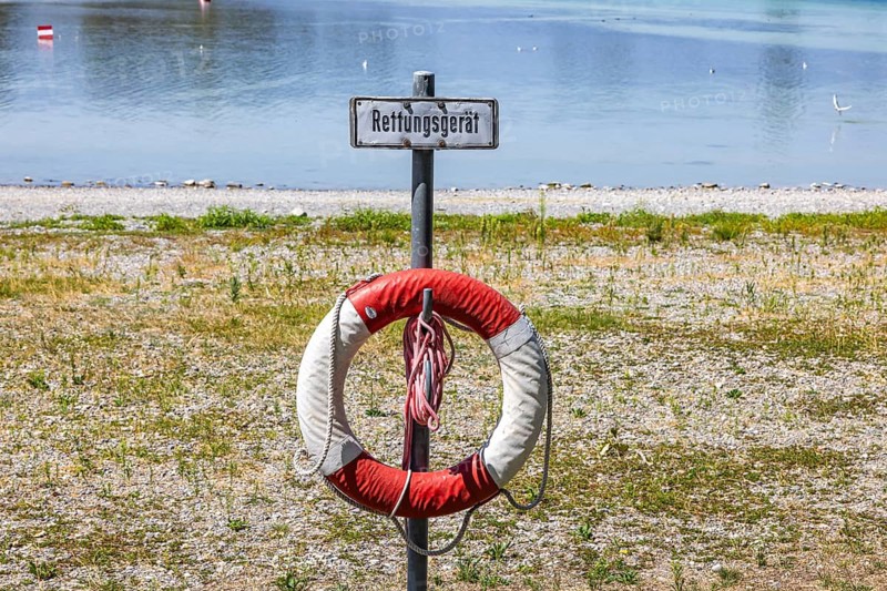 Beach on the island of Reichenau in Lake Constance. The low water level is a cause for concern. Access to water is difficult. A lifebuoy far from shore. Reichenau, Baden-Württemberg, Germany