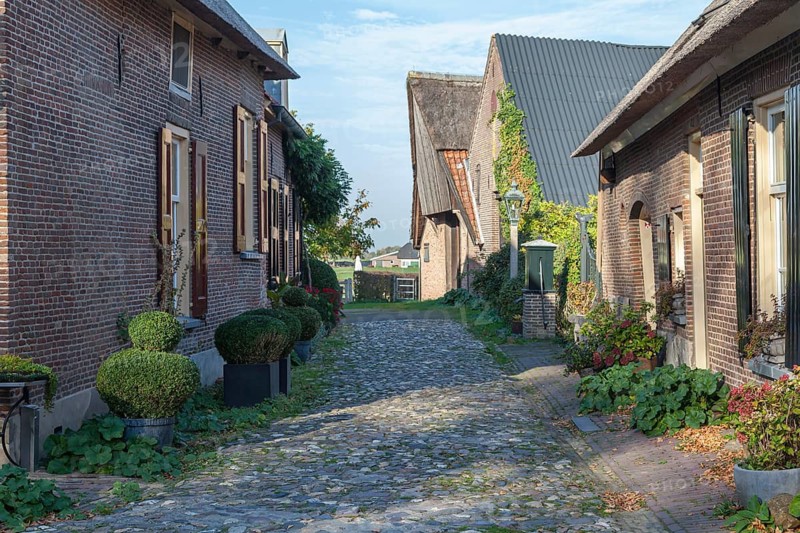 Street with brick houses and cobblestones in the small town of Bronkhorst, Bronckhorst municipality, Gelderland province, Netherlands