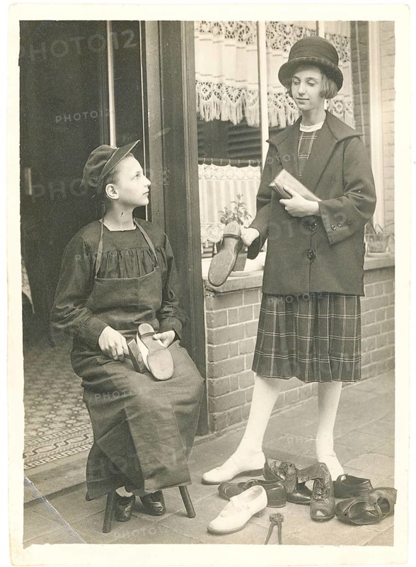 Boy cleaning shoes, older girl, solicitation, siblings, punishment, shoe repair, comedy, boy and girl standing with shoes in front of a shop, around 1926