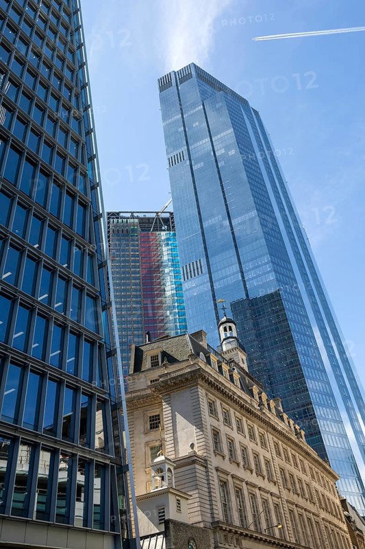 Glass facade of 22 Bishopsgate skyscraper rising above historic building stone architecture, City of London, London, England, UK