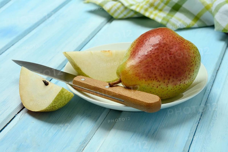 Pears on plate, cut with knife