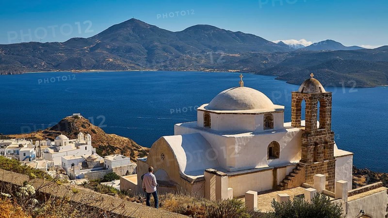 Church of Panagia of Thalassitra, Panagia Thalassitra, person in front of a church with sea view and mountains in the background on an island, Plaka, capital on Milos, island of Milos, volcanic island, Cyclades, Greek islands, Greece