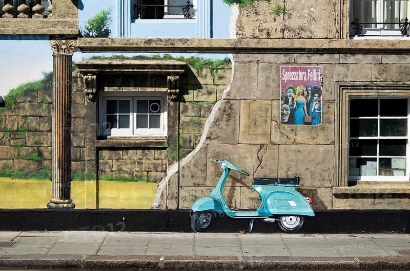 A turquoise painted roller on an illusionistically painted house façade and vintage posters, 143 Old Church Street, Royal Borough of Kensington and Chelsea, London, Great Britain, England, Great Britain