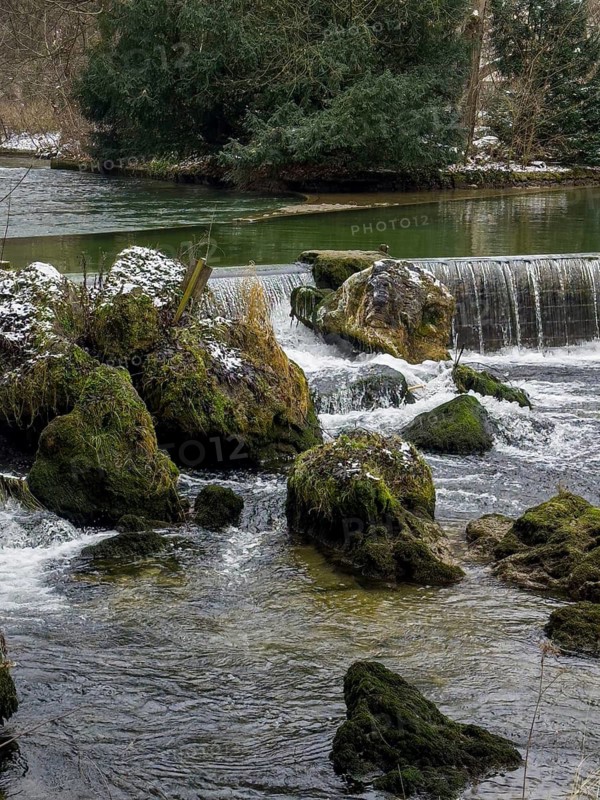 Small waterfall, winter in the English Garden, Munich, Bavaria, Germany