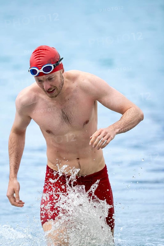 Swimmer comes out of the water after the swimming stage, Tegernsee Triathlon, Tegernsee, Upper Bavaria, Bavaria, Germany