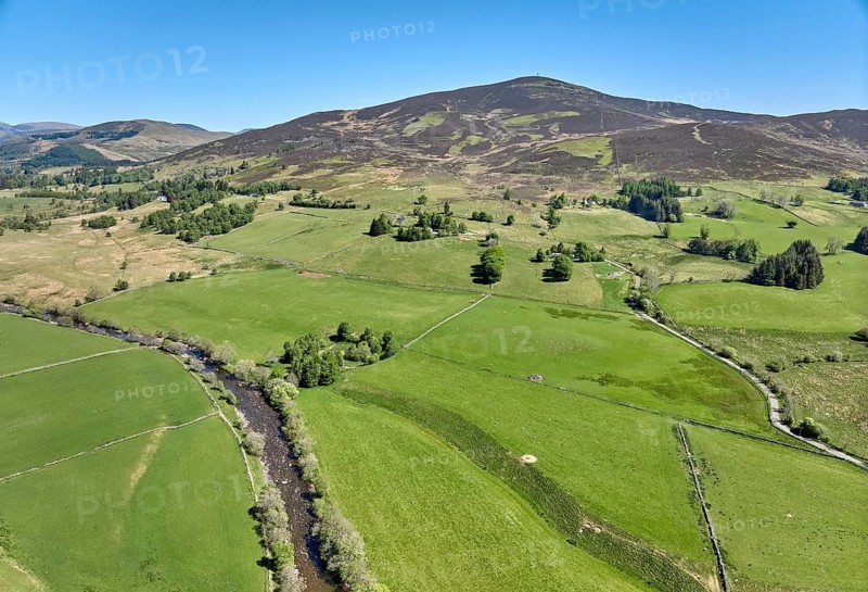 Aerial drone photo of agricultural landscape with meadows and pastures at the border of the Cairn Gorm National Park, Scotland, UK
