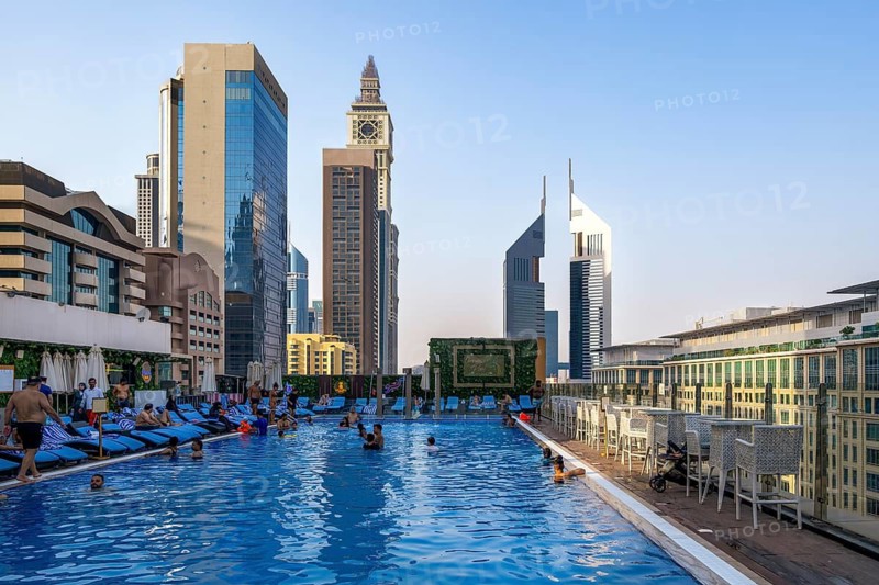 Swimming pool with view of Al Yaqoub Tower and Emirates Towers, Dubai, United Arab Emirates, UAE
