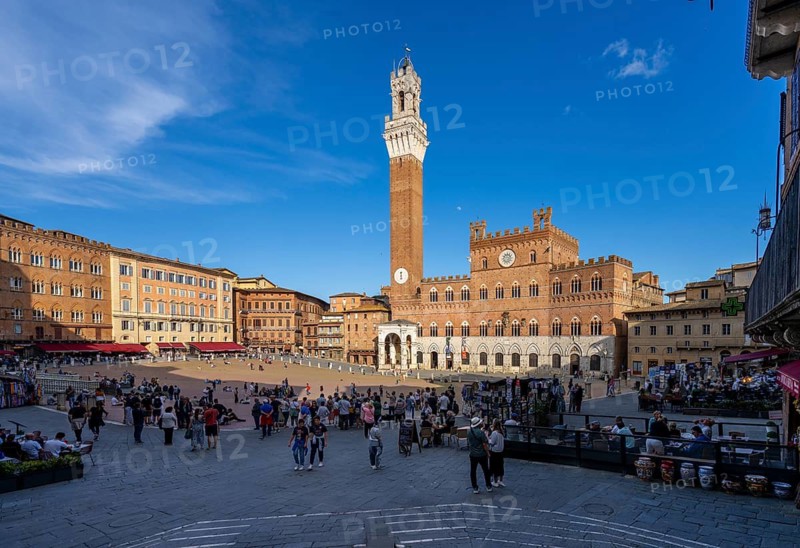 Tourists, sights and restaurants on the famous Piazza del Campo, Siena, Tuscany, Italy