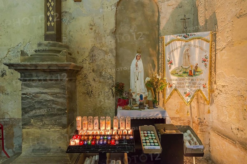 Burning commemorative candles in a church