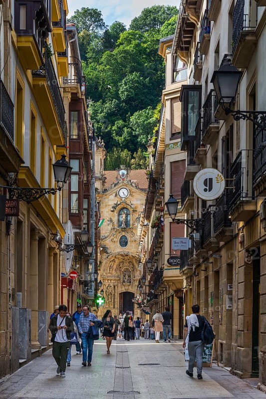 The shopping street Calle Mayor with the Basilica of Santa María del Coro in San Sebastian, Basque Country, Spain