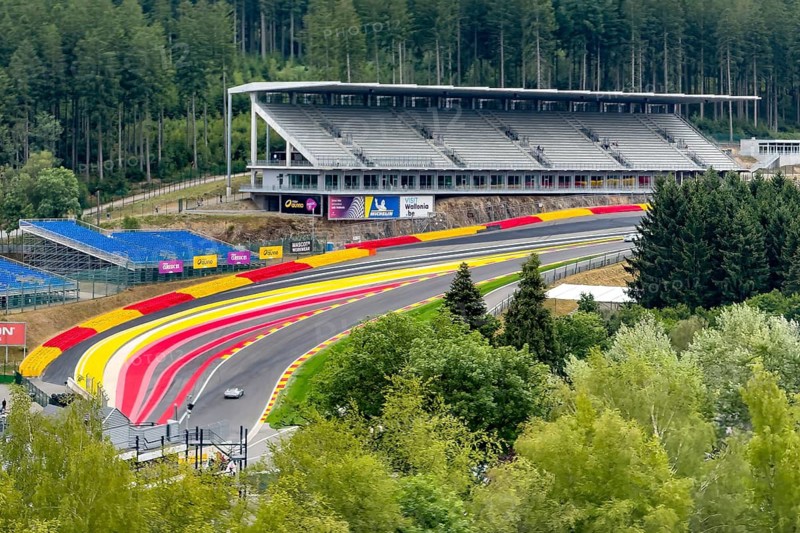 View from an elevated location of world-famous, steep steep right turn Raidillon from Circuit de Spa-Francorchamps Spa Francorchamps with road markings Boundary of Formula One F1 race track, behind large grandstand, Stavelot, Ardennes, Walloon region Wallonia Wallonia, Belgium