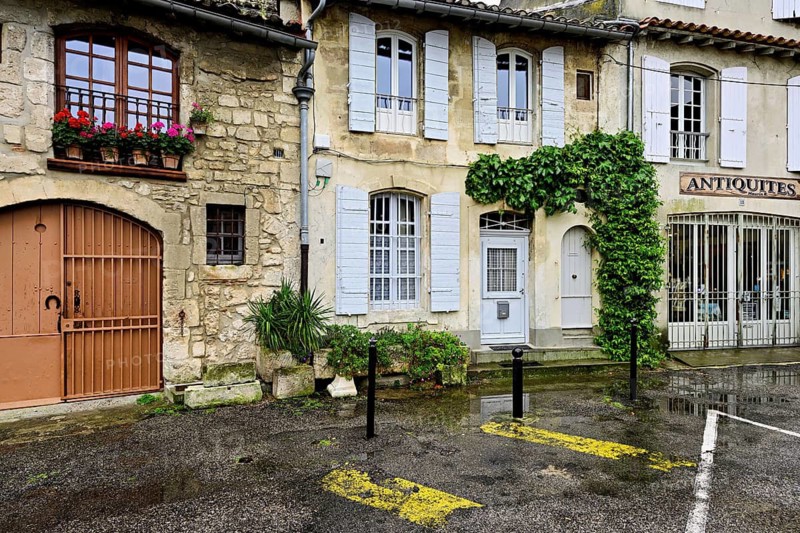 Green house facades in a district street in the city, Arles, Camargue, southern France, France