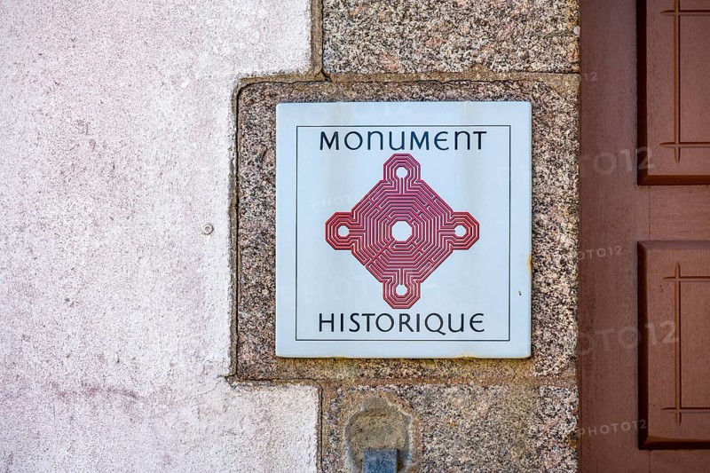 Sign with official logo for French cultural monuments Monument historique, historical monument at Saint-Mathieu Abbey, Pointe Saint-Mathieu, Plougonvelin, Brest Arrondissement, Finistère Department, Brittany region, France