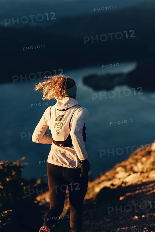 Trail running in autumn on the Jochberg on Lake Walchensee against the wonderful backdrop of the Alps, Bavaria, Germany