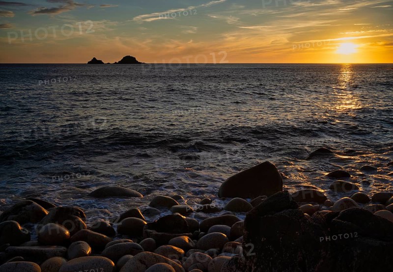 Evening, sunset at sea, in the background rock formation The Brisons, Cot Valley Beach, Porth Nanven, also beach of dinosaur eggs, coast, St Just in Penwith, Cornwall, England, Great Britain, Great Britain