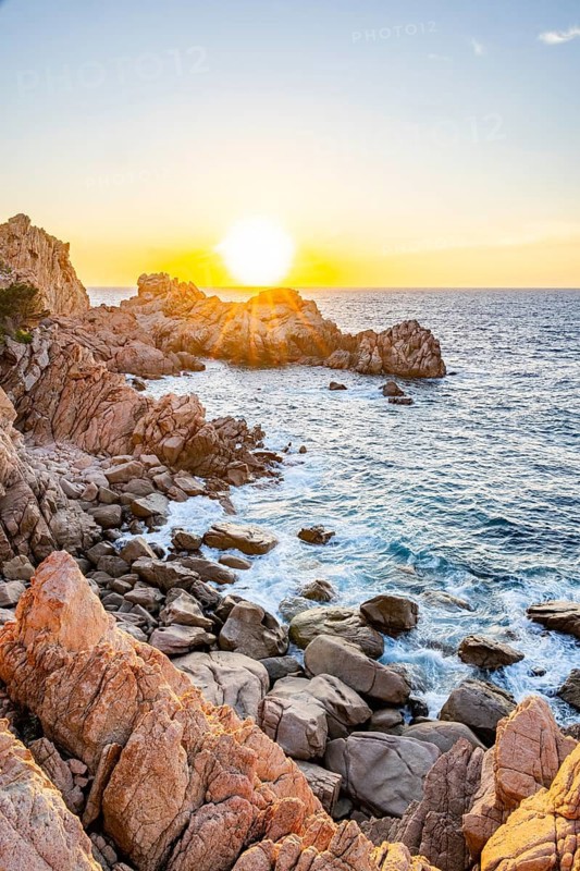 Landscape of the coastline with blue water at Costa Paradiso on a sunny day at sunset, Sardinia, Italy