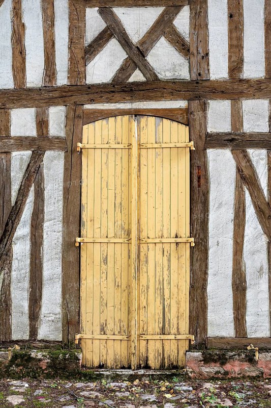 Old, dilapidated wooden door on a half-timbered house in the old town of Troyes, Aube department, Grand Est region, France