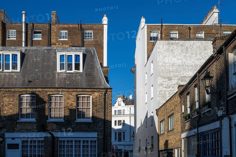 Brick town houses under blue sky, Borough of Chelsea and Kensington, London, England, Great Britain